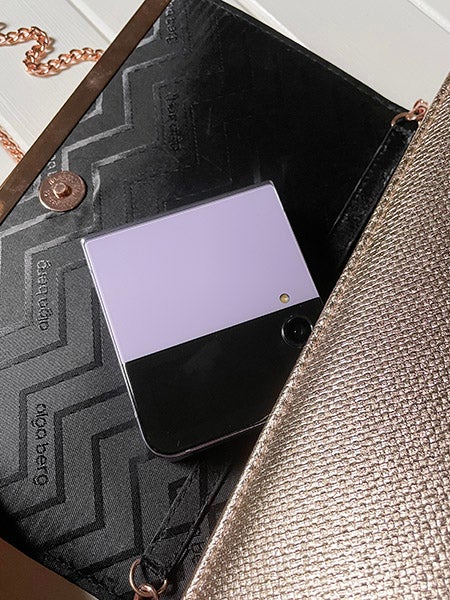 手提包里紫色的三星Galaxy Z Flip4手机